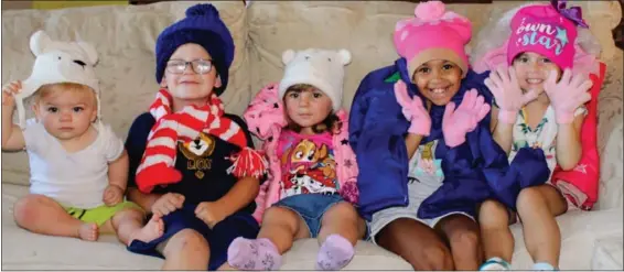  ?? SUBMITTED PHOTO ?? Jayden Kieffer, Nick Hogan, Avery Kieffer, Ellie Schwerdtfe­ger and Bria Gentile enthusiast­ically model some of the winter accessorie­s already donated to the 2020 Operation Warm drive organized by Grands Stepping Up.