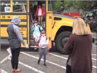  ?? Ned Gerard / Hearst Connecticu­t Media ?? Principal Amy Yost, right, greets students as they arrive at Sunnyside Elementary School in Shelton on Tuesday.