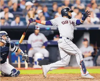  ?? KATHY WILLENS/ASSOCIATED PRESS FILE ?? Carlos Santana connects for a home run for Cleveland against the New York Yankees in postseason play in 2017. Santana is returning to the Indians in a three-team deal that involved Tampa Bay and Seattle.