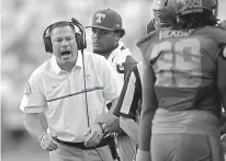  ?? AP Photo/Wade Payne, File ?? n Tennessee head coach Butch Jones yells to his players during the second half of an NCAA college football game against Florida on Sept. 24 in Knoxville, Tenn. The upcoming bowl games give the Southeaste­rn Conference a chance to earn redemption after a...