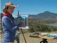  ??  ?? Below: Tobi Clement painting in plein air.