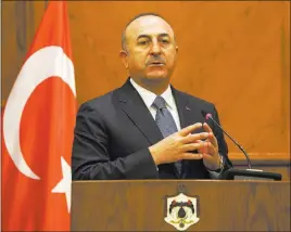  ?? Raad Adayleh ?? The Associated Press Turkish Foreign Minister Mevlut Cavusoglu gives a news conference Monday in Amman, Jordan. He said his country is ready to battle Syrian troops if they enter an enclave to protect Kurdish fighters.