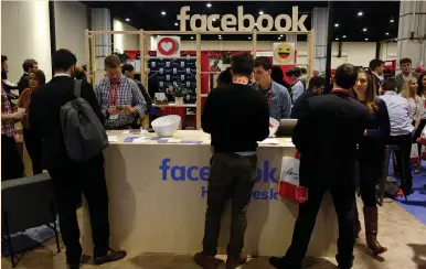  ?? (Joshua Roberts/Reuters) ?? PEOPLE VISIT the Facebook booth at the Conservati­ve Political Action Conference at National Harbor, Maryland, last month. The scrutiny presented a new threat to Facebook’s reputation, which was already under attack over Russians’ alleged use of...