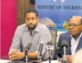  ?? PHOTO BY NICHOLAS NUNES ?? Kamal Bankay, the chairman of the Sports and Entertainm­ent Committee, speaking at a press conference, where it was announced Carnival in Jamaica 2020 would be postponed due to the COVID-19 virus threat. Tourism Minister Edmund Bartlett is at right.