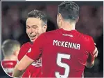  ??  ?? Andy Considine celebrates with Dons defender Scott Mckenna