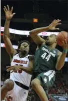  ?? TIMOTHY D. EASLEY — THE ASSOCIATED PRESS ?? Michigan State’s Nick Ward, right attempts a layup over the defense of Louisville’s Steven Enoch Tuesday night.