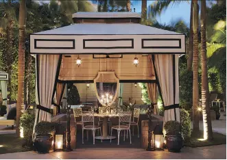  ?? THE MONACELLI PRESS ?? Cabanas in the backyard, embellishe­d with mirrors and lanterns, add elegance to at-home wedding celebratio­ns, particular­ly for evening weddings and receptions.