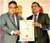  ??  ?? HNB Head of Human Capital Management, Indrajith Senadhira receiving the award for Best Employer Brand 2019 from Minister of Education, Akila Viraj Kariyawasa­m.