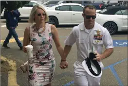  ?? JULIE WATSON — THE ASSOCIATED PRESS ?? Navy Special Operations Chief Edward Gallagher walks with his wife, Andrea Gallagher, as they arrive to military court on Naval Base San Diego on Thursday.