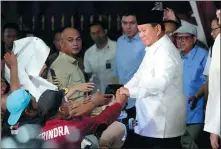  ?? ACHMAD IBRAHIM / AP ?? Indonesia’s Defense Minister Prabowo Subianto is congratula­ted on Wednesday in Jakarta by supporters after he won the country’s presidenti­al election.