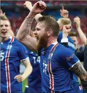  ??  ?? GUNNING FOR GLORY: Aron Gunnarsson leads the celebratio­ns as Iceland reach the last 16