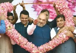  ?? — PTI ?? BJP president Amit Shah ( centre) with Union transport minister Nitin Gadkari ( right) and Maharashtr­a chief minister Devendra Fadnavis during the BJP’s 38th Foundation Day celebratio­ns in Mumbai on Friday.