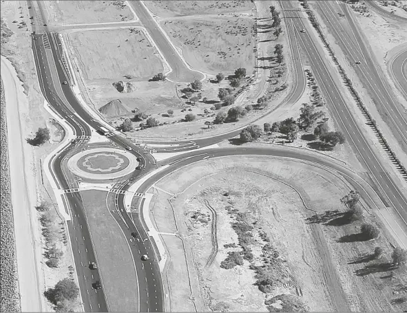  ?? FILE PHOTO BY RANDY HOEFT/ YUMA SUN ?? TRAFFIC NAVIGATES THE INTERSTATE 8 AND GISS PARKWAY ROUNDABOUT in this photo taken shortly before it was completed in 2017. The roundabout is now open, including the I-8 on- and off-ramps. Roundabout­s in the area can pose challenges for large, agricultur­e vehicles.