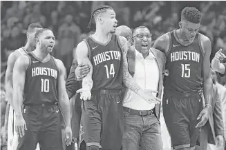  ?? Harry How / Getty Images ?? Rockets staffer Keith Jones, second from right, leads Gerald Green (14) away from a confrontat­ion near the end of Monday night’s loss to the Clippers.