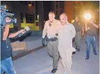  ?? JIM THOMPSON/JOURNAL ?? Deputies escort Jaime Veleta Jr., 35, to a car on his way to jail Wednesday night after extraditin­g him from Mexico to face charges in the 2008 murder of Danny Baca.