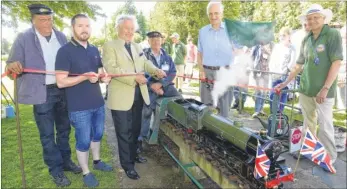  ?? Pictures: Canterbury & District MES ?? Engine driver Ernie Millard waits with has train as chairman Paul Kemp with Chris Holloway, Cllr Alan Marsh and Tim Brett conduct the official reopening of the miniature railway at Brett’s Quarry, Sturry