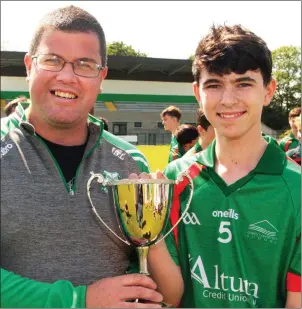  ??  ?? Brian Lonergan presenting the Marty Barrett Cup to Farrell Doyle after Gorey Community School defeated St. Peter’s College in the final in Páirc Uí Shíocháin.