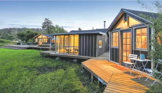  ?? Photos by Open Homes Photograph­y ?? Above: A wood deck sprawls off the great room and wraps around the Bolinas home at 116 Olema Bolinas Road. Below: In addition to a pair of studios, the Bolinas listing includes a large barn.