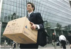  ?? Reuters ?? A worker carries a box from the Lehman Brothers offices in Canary Wharf, London, on September 15, 2008