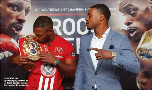  ??  ?? PRIDE AND JOY: Spence [right] watches on as Brook plants a kiss on his coveted IBF welter belt