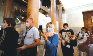  ?? (Mussa Qawasma/Reuters) ?? TOURISTS VISIT the Church of the Nativity in Bethlehem yesterday.