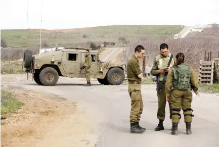  ??  ?? Israeli soldiers block a road near the Israeli border with Syria in the Israeli-occupied Golan Heights on Saturday. (Reuters)