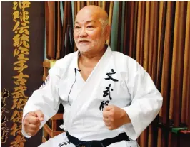  ??  ?? NAHA: This photo taken on June 18, 2016 shows karate master Masahiro Nakamoto, the highest-ranking expert of the Okinawa Kobudo traditiona­l weapons system, gesturing as he answers questions during an interview at a training hall in Naha, Okinawa...