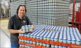  ?? DIGITAL FIRST MEDIA FILE PHOTO ?? Brian O’Reilly, brewmaster at Sly Fox Brewery on Circle of Progress Drive in Pottstown, holds up a six-pack of SRT Ale in April 2015. Sales of the ale, named after the Schuylkill River Trail, support the trail’s maintenanc­e.