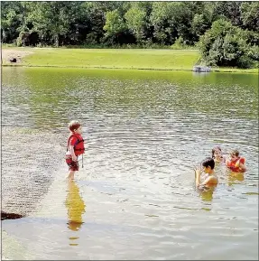  ?? Lynn Atkins/The Weekly Vista ?? Desdan, Nyas, London and Cayman Wagner play in the water at Lake Avalon almost every day, their older sister, Aspen said. Last week they were swimming off the boat ramp, but next summer there will be a sand beach at the end of the cove. The drainage...