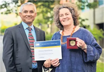 ?? PHOTO: LINDA ROBERTSON ?? Extraordin­ary work . . . Otago Medical School dean Prof Rathan Subramania­m and the winner of the Dean’s Medal for research excellence, Prof Sarah Derrett.