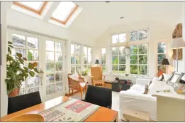  ??  ?? An abundance of natural light fills the delightful garden room, where French windows open up onto the property’s terrace