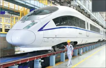  ?? WANG SHUTIAN / XINHUA ?? A high-speed train manufactur­ed by China Railway Rolling Stock Corp arrives at a maintenanc­e warehouse in Xi’an, Shaanxi province, in