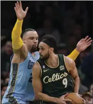 ?? (AP/Steven Senne) ?? Boston Celtics guard Derrick White (9) drives to the basket as Memphis Grizzlies forward Dillon Brooks defends during the second half Sunday in Boston. White scored 23 points in a 119-109 victory.
