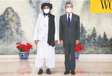  ?? LI RAN / XINHUA VIA AP ?? Chinese Foreign Minister Wang Yi, right, welcomed a nine-member delegation from the Taliban that included
chief negotiator and top political leader Mullah Abdul Ghani Baradar in Tianjin, China, on Wednesday.
