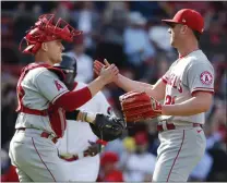  ?? MICHAEL DWYER – THE ASSOCIATED PRESS ?? The Angels’ Mike Mayers, right, and Max Stassi exchange accolades after defeating the Boston Red Sox on Thursday at Fenway Park.