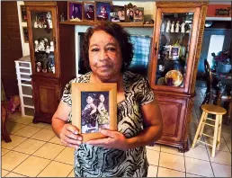  ?? MOLLY HENNESSEY-FISKE/LOS ANGELES TIMES/TNS ?? Nelda Lugo, 63, holds a photo of her, granddaugh­ters Eliana Garcia, 9, left, and Janel Garcia, 11. Eliana was killed in the school shooting at Robb Elementary School in Uvalde, Texas.