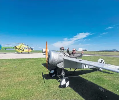  ??  ?? Russell celebrates his achievemen­t at the controls of the replica First World War Fokker aircraft.