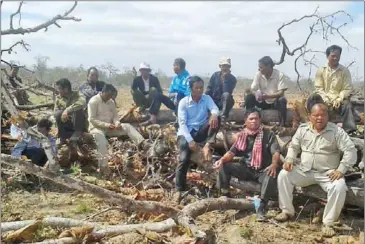  ?? LICADHO ?? Ethnic Tompuon villagers sit in a section of forest in Ratanakkir­i’s Lumphat district during an ongoing land dispute with an economic land concession.