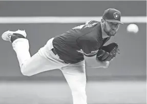  ?? BENNY SIEU / USA TODAY SPORTS ?? Brewers starter Adrian Houser delivers to the plate in the first inning. The right-hander pitched six strong innings, allowing only three hits.