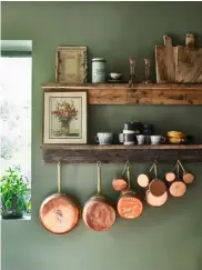  ??  ?? THIS PAGE, FROM FAR LEFT Against camouflage-green walls, a set of rustic shelves displays chopping boards, while bright copper pans add warm tones;