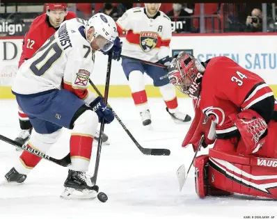  ?? KARL B DEBLAKER AP ?? Panthers’ Patric Hornqvist tries to control the puck in front of Hurricanes goaltender Petr Mrazek. The puck didn’t bounce favorably for Florida in Tuesday’s loss at Carolina.
The Panthers gave up two power-play goals and scored an own goal to fall to the Carolina Hurricanes, and end a season-best six-game winning streak.