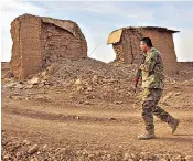  ??  ?? An Iraqi soldier surveys the destructio­n caused by Isil at Nimrud