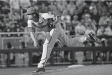  ?? Peter Aiken, Getty Images ?? Arkansas pitcher Blaine Knight delivers against Oregon State during Game 1 of the College World Series Championsh­ip Series on Tuesday in Omaha.