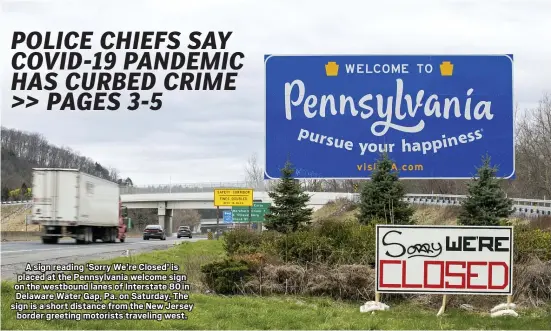  ?? ASSOCIATED PRESS ?? A sign reading ‘Sorry We’re Closed’ is placed at the Pennsylvan­ia welcome sign on the westbound lanes of Interstate 80 in Delaware Water Gap, Pa. on Saturday. The sign is a short distance from the New Jersey
border greeting motorists traveling west.