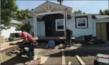  ?? DAN HONDA — BAY AREA NEWS GROUPS/MCT ?? A crew works on a home being renovated in Concord, Calif., on April 23, 2014. The renovation was on the HGTV show “Flip It To Win It,” where teams of house flippers pair with real estate agents.