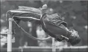  ?? ?? JOHNSON, here warming up for the high jump, will attend California where he’ll continue a track career.