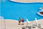  ??  ?? Tourists staying next to an empty pool in Sunny Beach, Bulgaria’s biggest Black Sea resort.