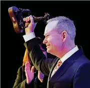  ?? [PHOTO BY STEVE SISNEY, THE OKLAHOMAN] ?? Oklahoma City Mayor Mick Cornett holds the Greater Oklahoma City Chamber’s Hot Brand award Thursday at the Cox Convention Center.