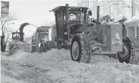  ?? ALLEN MCINNIS/ THE GAZETTE ?? A snow removal crew clears Notre-Dame St. near the Atwater Market on Monday. The city’s Jacques-Alain Lavallée says having to tow cars just slows down snow-clearing operations.