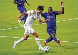  ?? JOHN RAOUX / ASSOCIATED PRESS ?? AtlantaUni­tedmidfiel­der Jurgen Damm(left) tries to get past Orlando City defender KamalMille­r during their gameWednes­day.